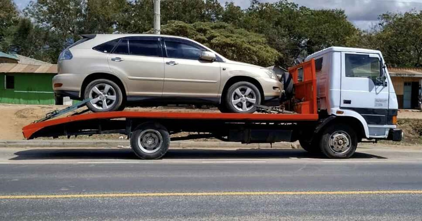 Beige SUV safely loaded on flatbed tow truck in Rosemead